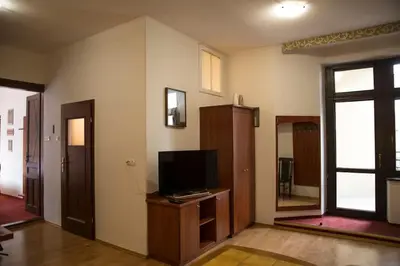 a living room with a tv on a wooden stand at Kompleksowo wyposażony apartament w centrum in Kraków