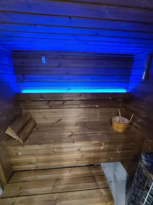 a large wooden bed with a blue light on it at Domek Bocianie Gniazdo in Stradomka