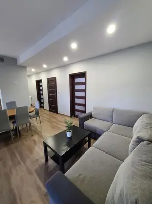 a living room with a couch and a table at Domek Bocianie Gniazdo in Stradomka