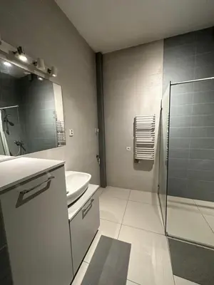 a bathroom with a sink and a toilet and a mirror at City Center Apartment in Kraków