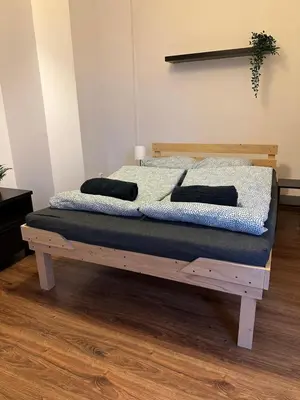 a bed with two pillows on it in a room at City Center Apartment in Kraków