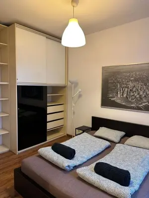 a living room with two beds in a room at City Center Apartment in Kraków