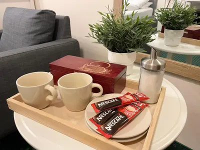 a coffee table with two cups and snacks on it at Gertrudy 10 Residence - 1-Minute Walk to the Old Town in Kraków