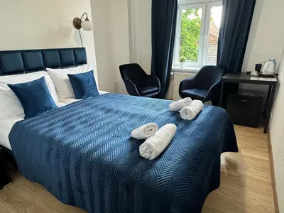 a bedroom with a bed with towels on it at IRIS Aparthotel in Kraków