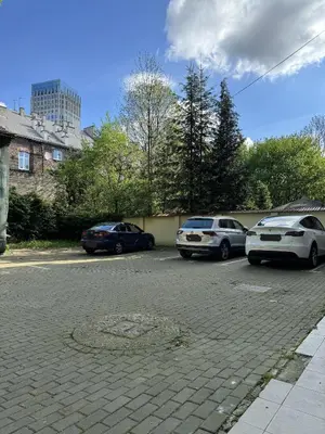 a group of cars parked in a parking lot at IRIS Aparthotel in Kraków