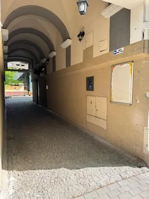 an empty hallway of a building with an archway at IRIS Aparthotel in Kraków