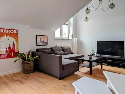a living room with a couch and a flat screen tv at Starowiślna 34 by Homeprime in Kraków