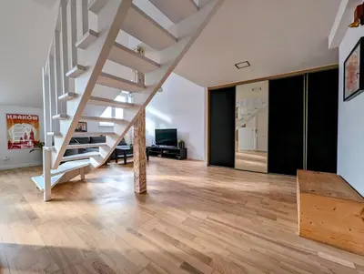 a living room with a staircase in a house at Starowiślna 34 by Homeprime in Kraków