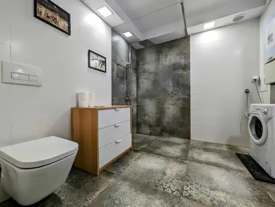 a bathroom with a toilet and a washing machine at Starowiślna 34 by Homeprime in Kraków