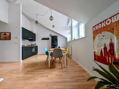a dining room with a table and chairs at Starowiślna 34 by Homeprime in Kraków