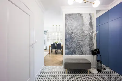 a living room with a blue and white wall at Native Apartments Orawska 14/127 in Kraków