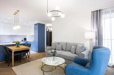 a living room with a couch and a table at Native Apartments Orawska 14/127 in Kraków