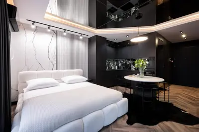a bedroom with a white bed and a table at Native Apartments Kościuszki 39/22 in Kraków