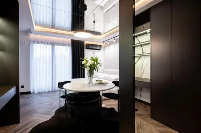 a dining room with a table with flowers on it at Native Apartments Kościuszki 39/22 in Kraków