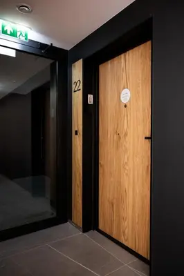 a wooden door with a sign on it in a room at Native Apartments Kościuszki 39/22 in Kraków