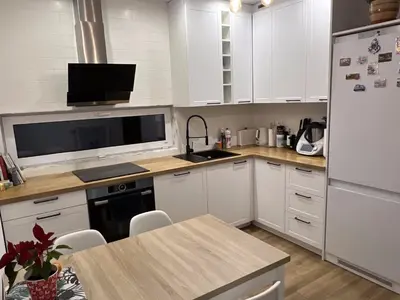 a kitchen with white cabinets and a white refrigerator at Cosy 3 room apartment close to Main Square in Kraków