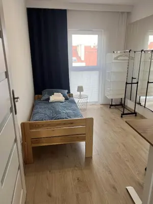 a bedroom with a bed in the middle of a room at Cosy 3 room apartment close to Main Square in Kraków