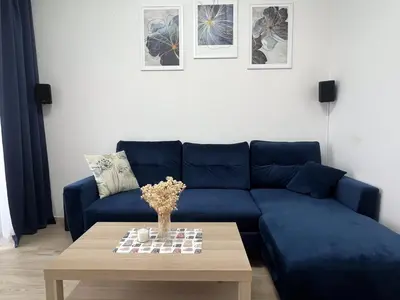 a blue couch in a living room with a coffee table at Cosy 3 room apartment close to Main Square in Kraków