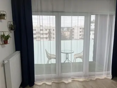 a room with a balcony with a table and chairs at Cosy 3 room apartment close to Main Square in Kraków