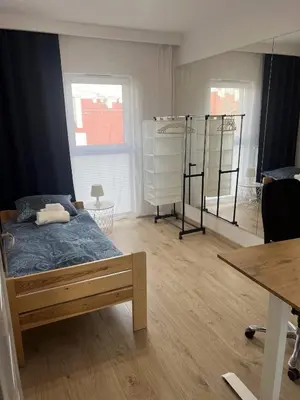 a bedroom with a bed and a desk and a table at Cosy 3 room apartment close to Main Square in Kraków