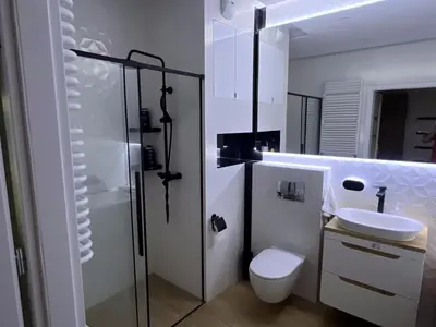 a white bathroom with a toilet and a sink at Cosy 3 room apartment close to Main Square in Kraków