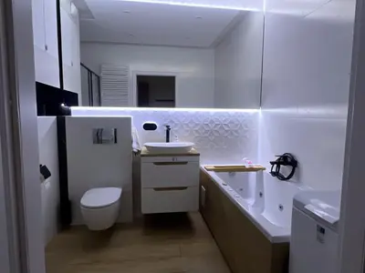a bathroom with a sink and a toilet and a tub at Cosy 3 room apartment close to Main Square in Kraków