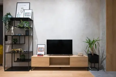 a living room with a tv on a wooden entertainment center at D21 Art Loft Apartment in Kraków