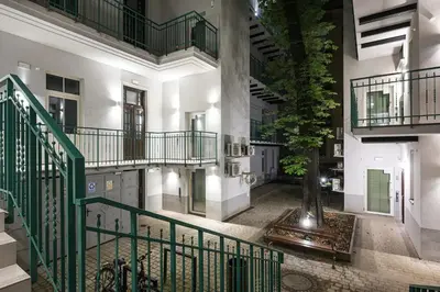 a building with a staircase and a tree in the middle at D21 Art Loft Apartment in Kraków