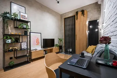 a living room with a table with a laptop on it at D21 Art Loft Apartment in Kraków