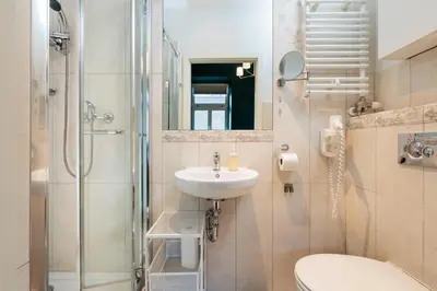 a bathroom with a toilet sink and a shower at Green Gertrudy in Kraków