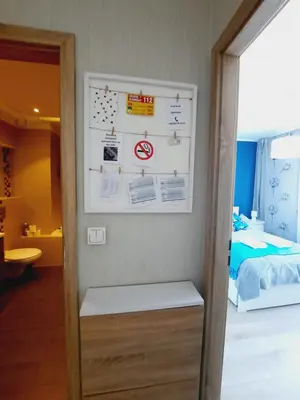 a room with a bed and a wall with signs at Apartament z podziemnym parkingiem ulica Wroclawska in Kraków