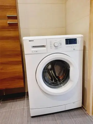 a white washing machine sitting in a room at Apartament z podziemnym parkingiem ulica Wroclawska in Kraków
