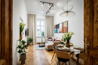 a living room with a table and a couch at Cracow Best Location Apartment No:6 by Cozyplace in Kraków