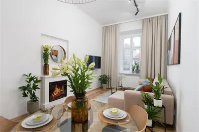 a living room with a table and a fireplace at Cracow Best Location Apartment No:6 by Cozyplace in Kraków