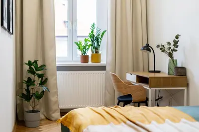 a bedroom with a desk and a chair next to a bed at Cracow Best Location Apartment No:6 by Cozyplace in Kraków