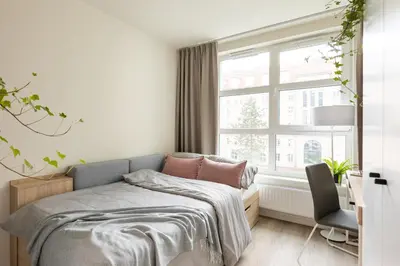 a bedroom with a bed and a window at MILESTONE Krakow Center Student Living by Tribera in Kraków