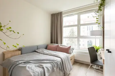 a bedroom with a bed and a window at MILESTONE Krakow Center Student Living by Tribera in Kraków