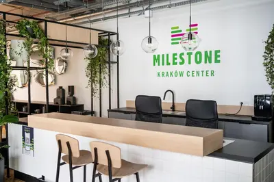 a meeting room with a reception counter with chairs at MILESTONE Krakow Center Student Living by Tribera in Kraków