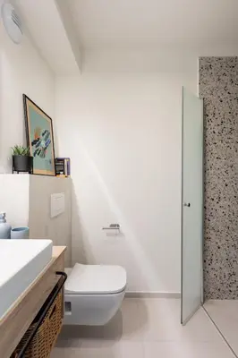 a white bathroom with a toilet and a sink at MILESTONE Krakow Center Student Living by Tribera in Kraków