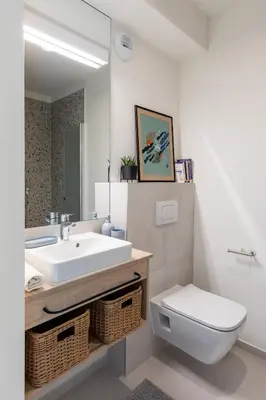 a bathroom with a white sink and a toilet at MILESTONE Krakow Center Student Living by Tribera in Kraków