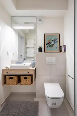 a bathroom with a sink and a toilet and a mirror at MILESTONE Krakow Center Student Living by Tribera in Kraków