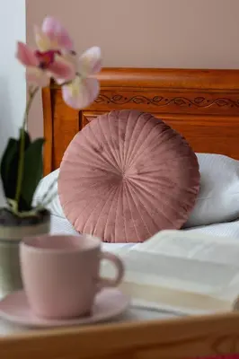 a pink paper fan and a cup on a bed at Modern Apartment with Parking in Cracow by Rent like home in Kraków