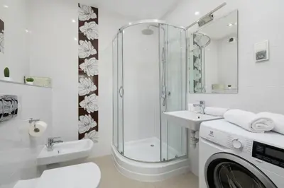 a bathroom with a shower sink and a washing machine at Modern Apartment with Parking in Cracow by Rent like home in Kraków