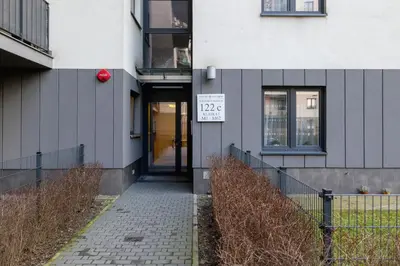 a building with a sign on the side of it at Modern Apartment with Parking in Cracow by Rent like home in Kraków