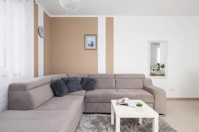 a living room with a couch and a table at Modern Apartment with Parking in Cracow by Rent like home in Kraków