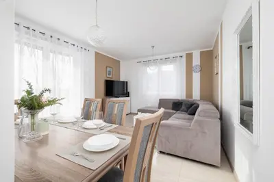 a living room with a table and a couch at Modern Apartment with Parking in Cracow by Rent like home in Kraków