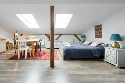 a bedroom with a bed and a table and chairs at Your stylish spot in the center of Kraków in Kraków