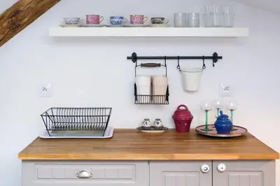 a kitchen with a wooden counter top and a shelf at Your stylish spot in the center of Kraków in Kraków