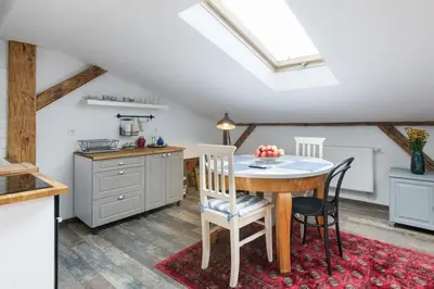 a kitchen with a table and chairs in a room at Your stylish spot in the center of Kraków in Kraków