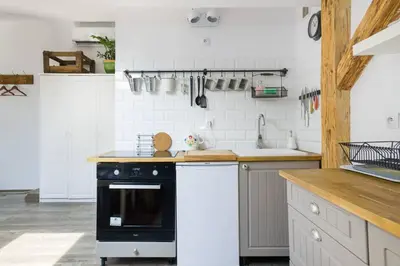 a kitchen with a black and white stove top oven at Your stylish spot in the center of Kraków in Kraków